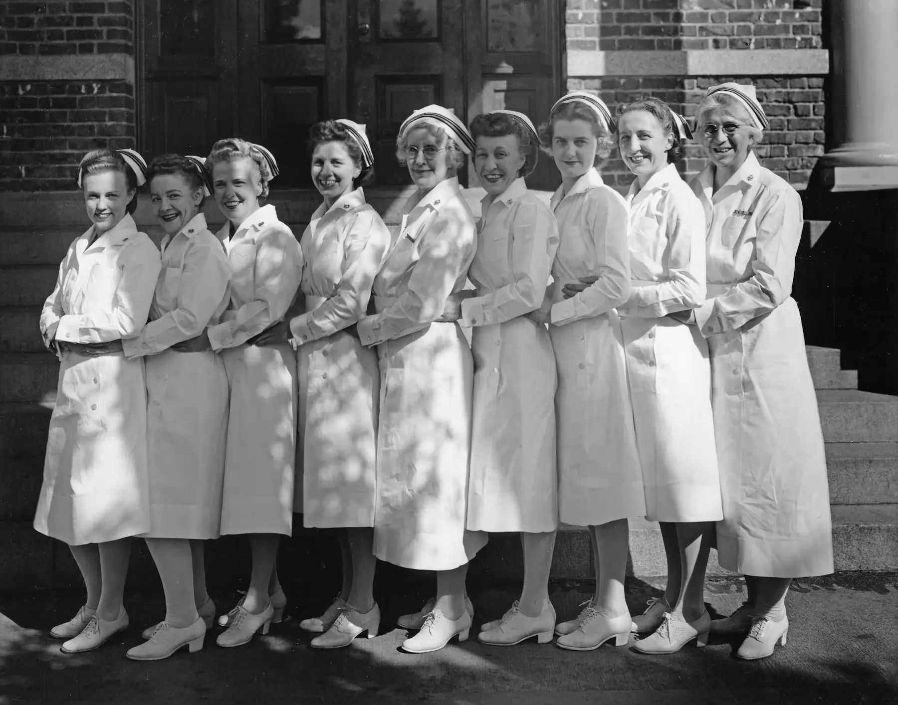 Nursing students in white uniforms from an earlier era